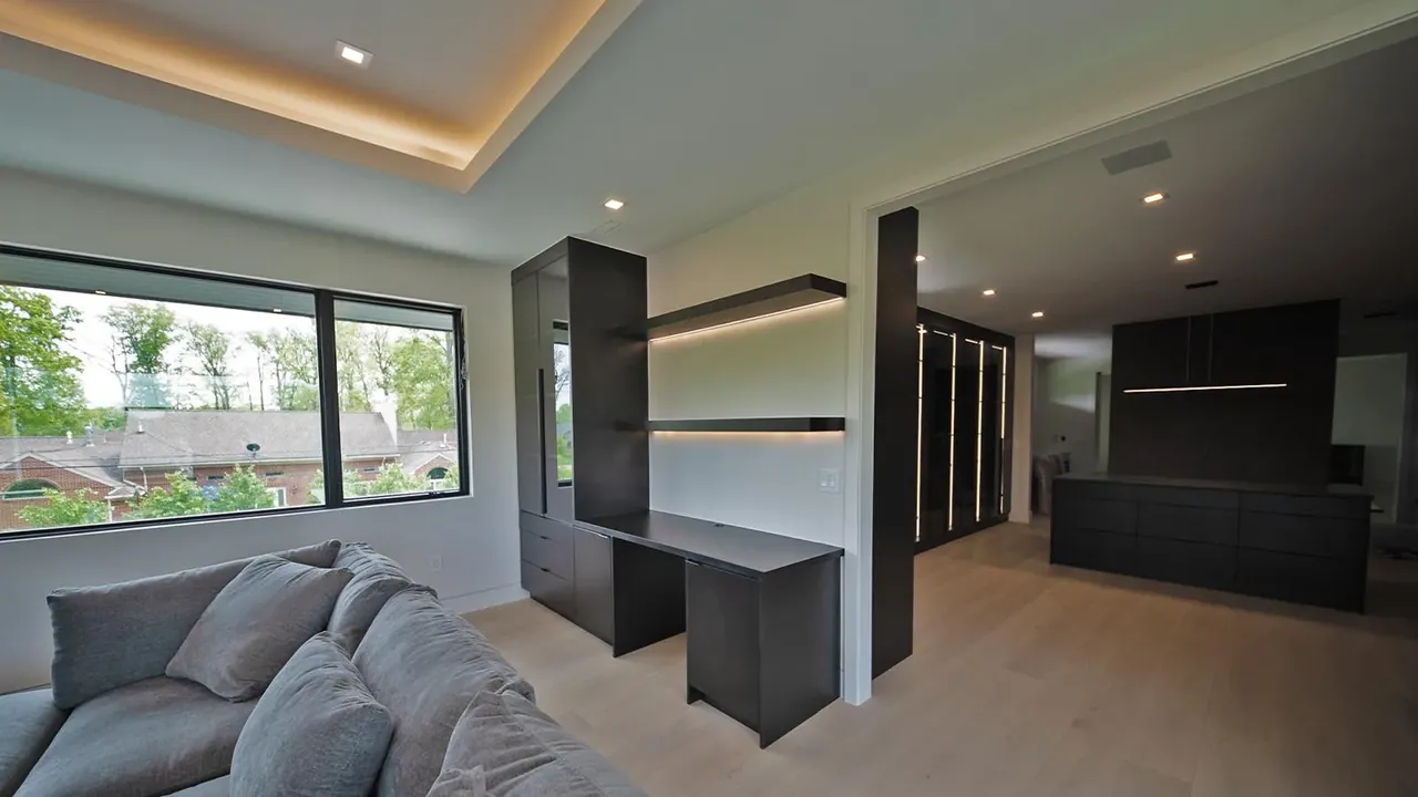 Bedroom built-ins with a black desk, floating shelves and tall black cabinets by Mason Oak Carpentry in Detroit, MI