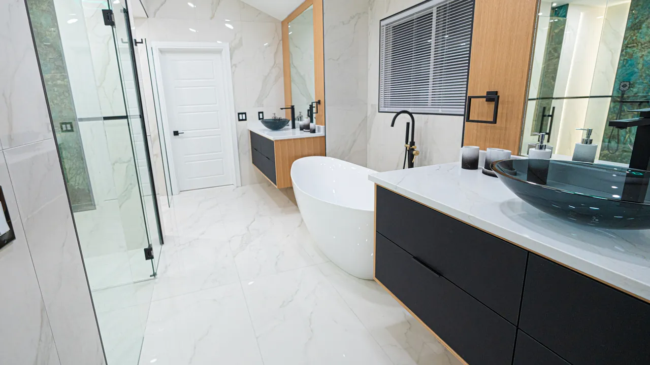 Floating black and oak vanity with a vessel sink beside a freestanding tub by Mason Oak Carpentry in Detroit, MI