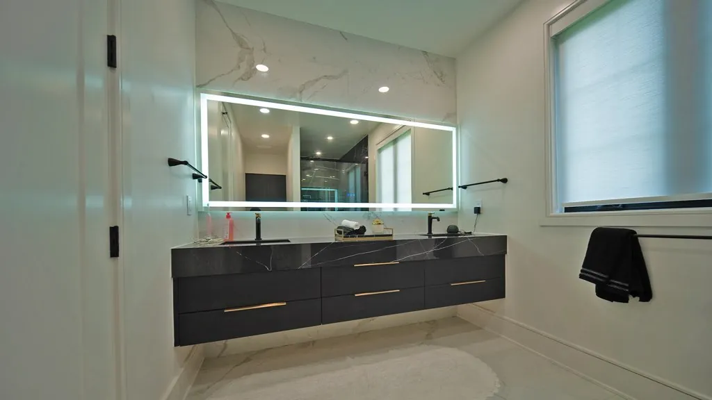 Floating charcoal double vanity with brass pulls by Mason Oak Carpentry in Detroit, MI