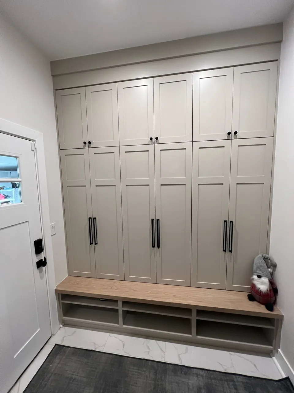 Mudroom lockers with tall cabinets and a built-in bench by Mason Oak Carpentry in Detroit, MI