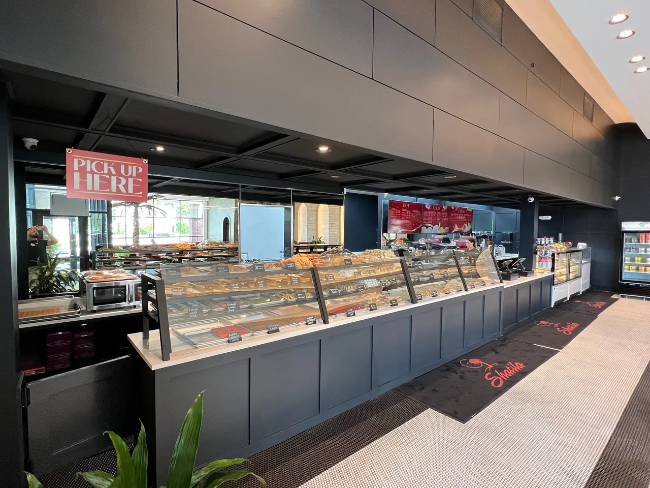 Bakery service counter with dark base cabinets under a long display case run by Mason Oak Carpentry in Detroit, MI