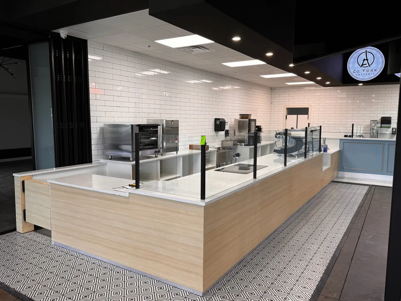Commercial service counter with a light wood front and black base cabinets by Mason Oak Carpentry in Detroit, MI