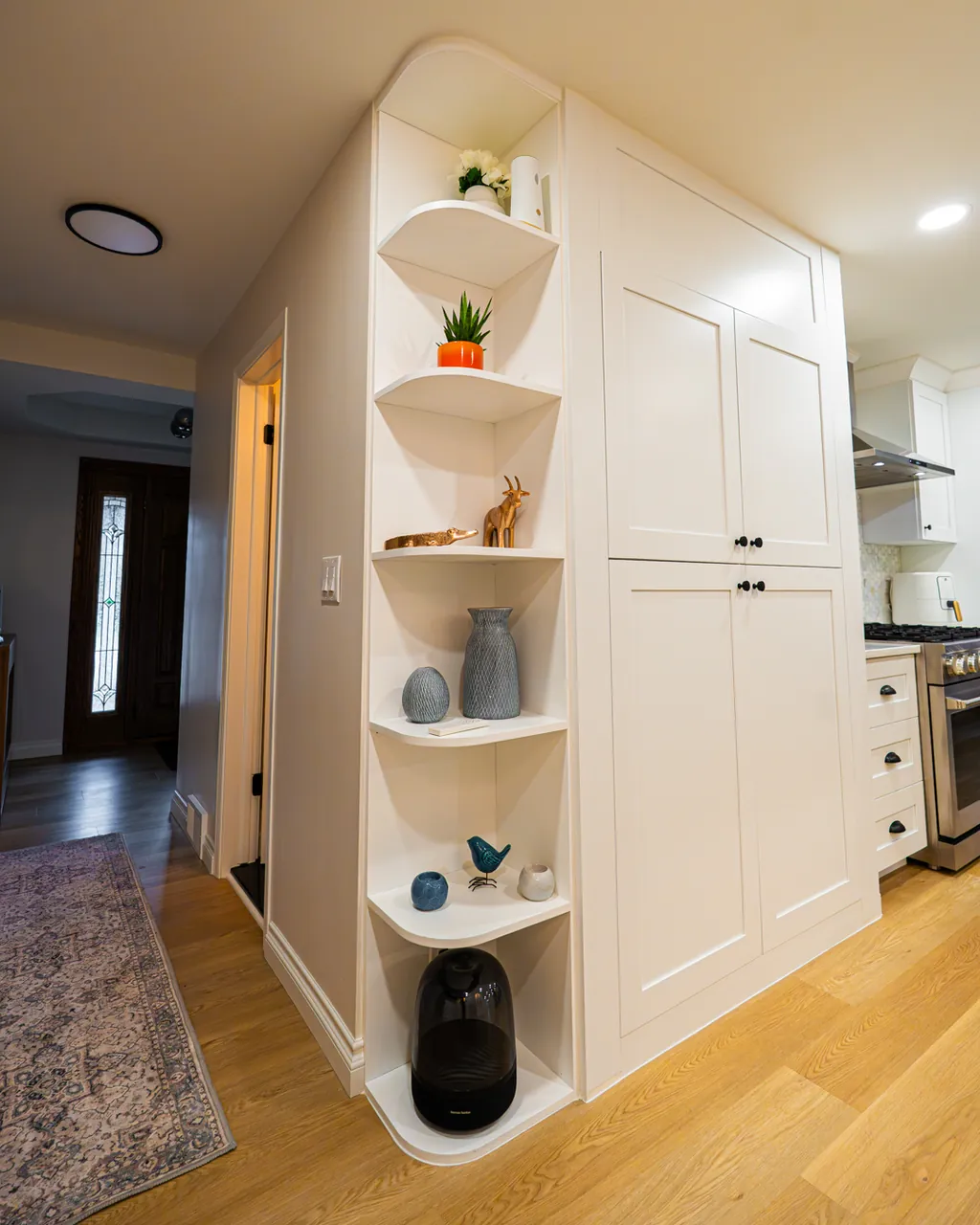 White pantry cabinets with curved open corner shelves by Mason Oak Carpentry in Detroit, MI
