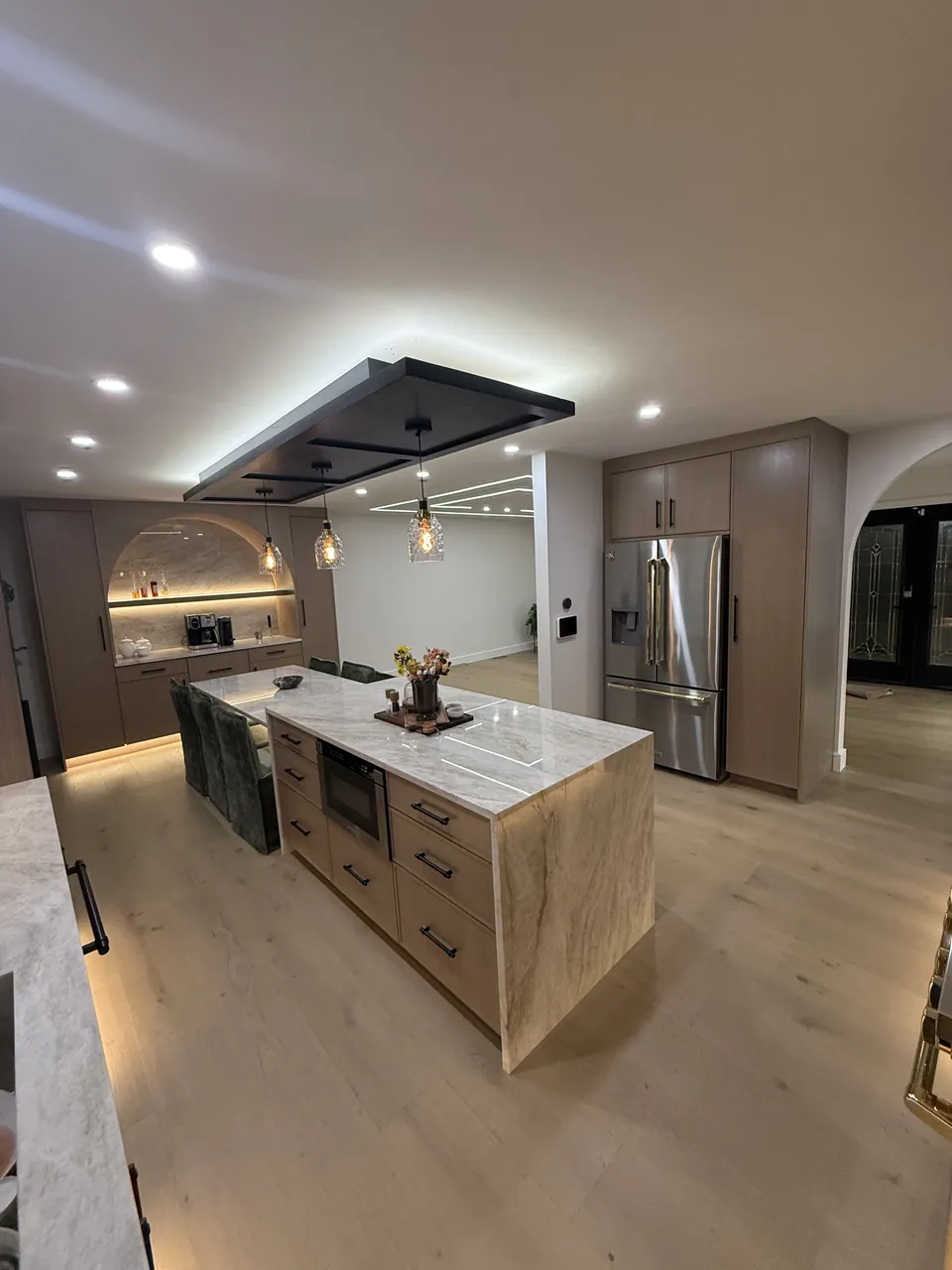 Kitchen with a waterfall island, a floating ceiling panel and wood tall cabinets by Mason Oak Carpentry in Detroit, MI