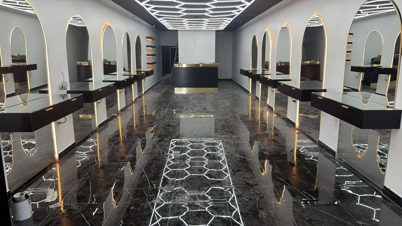 Salon fit-out with arched lit mirrors, floating stations and a hex light ceiling by Mason Oak Carpentry in Detroit, MI