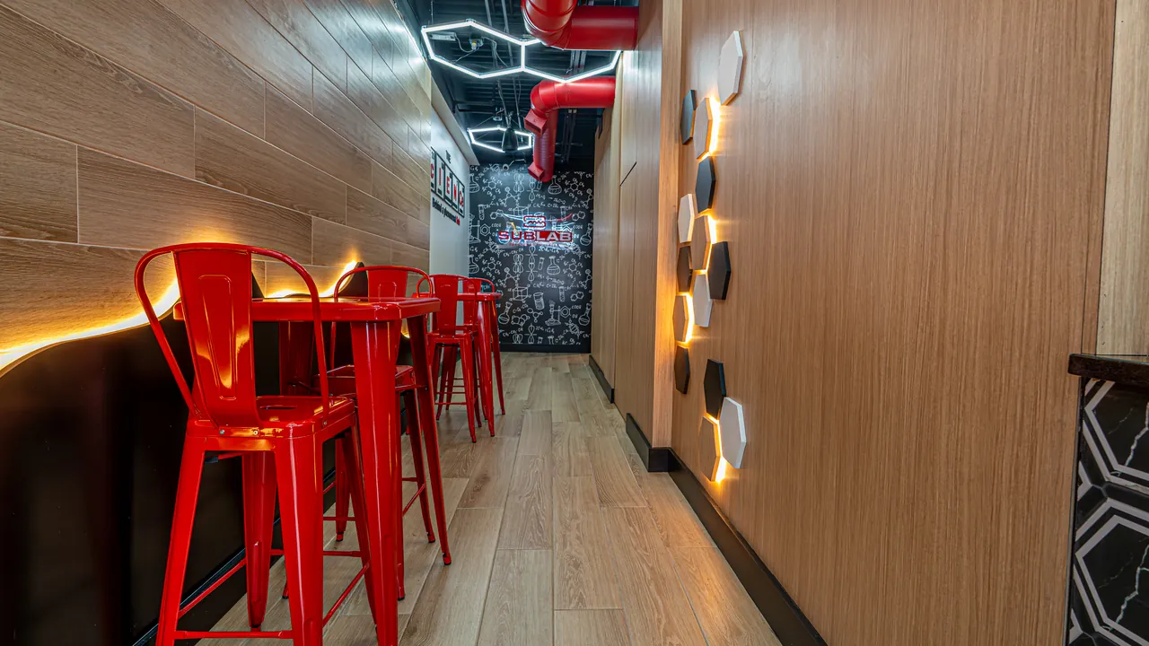 Restaurant seating along a curved wood wall with lighting by Mason Oak Carpentry in Detroit, MI