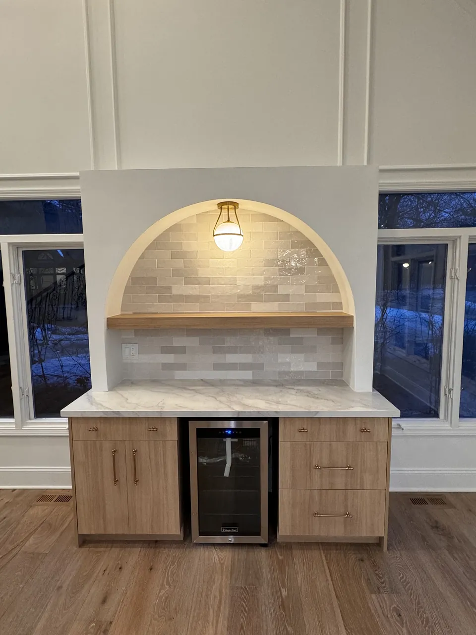 Coffee bar with an arched tile niche and light wood cabinets by Mason Oak Carpentry in Detroit, MI