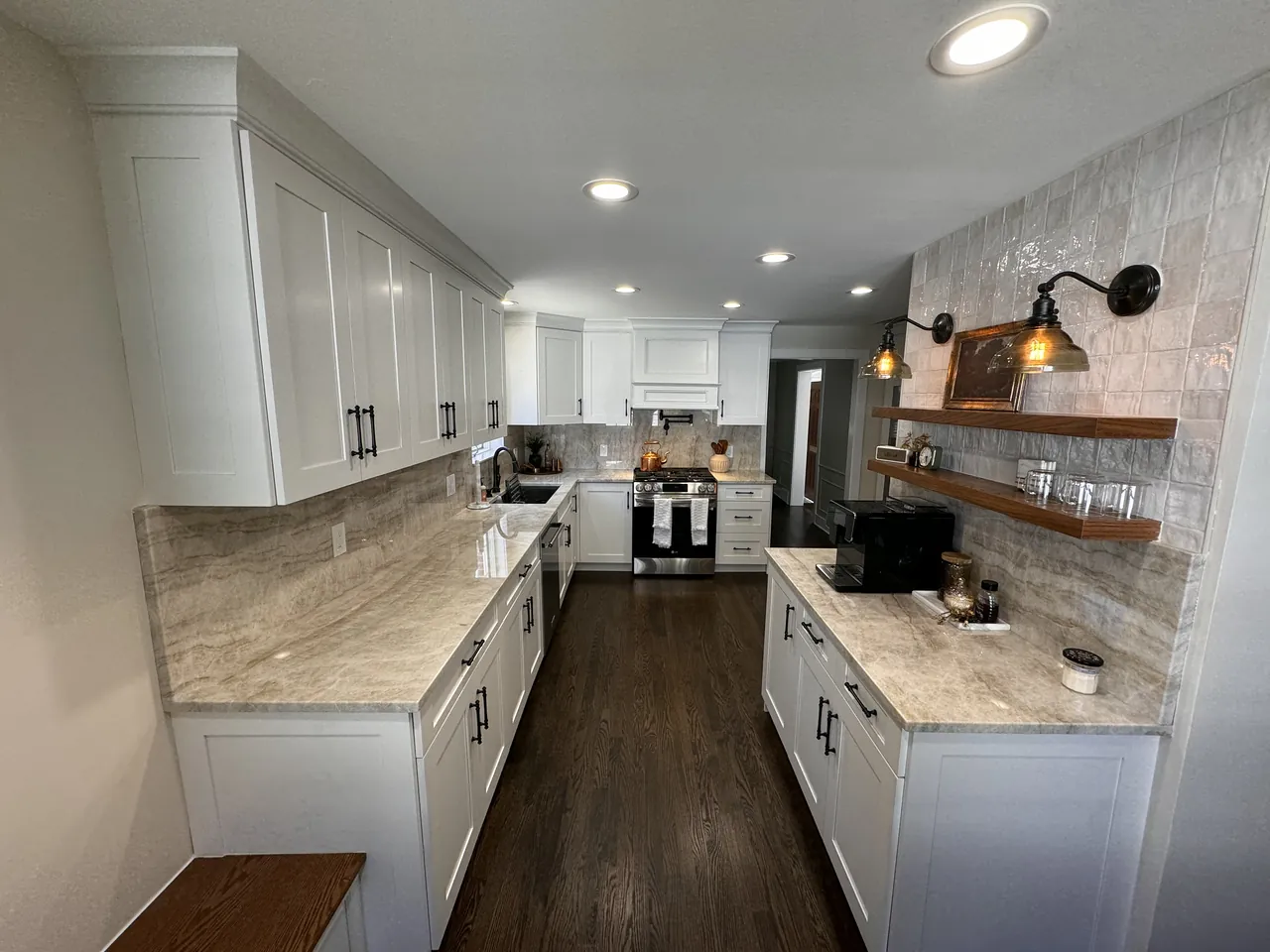White galley kitchen with floating wood shelves and a stone backsplash by Mason Oak Carpentry in Detroit, MI