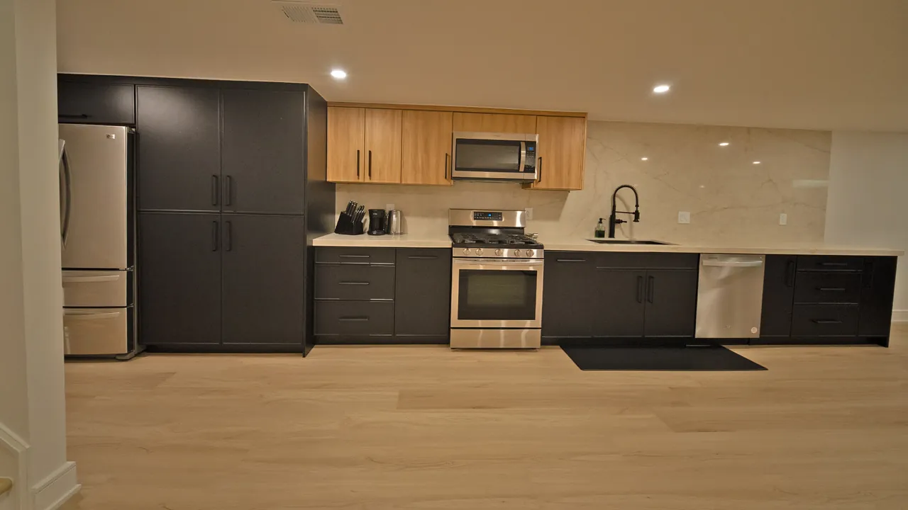 Basement kitchen with charcoal and light wood cabinets by Mason Oak Carpentry in Detroit, MI
