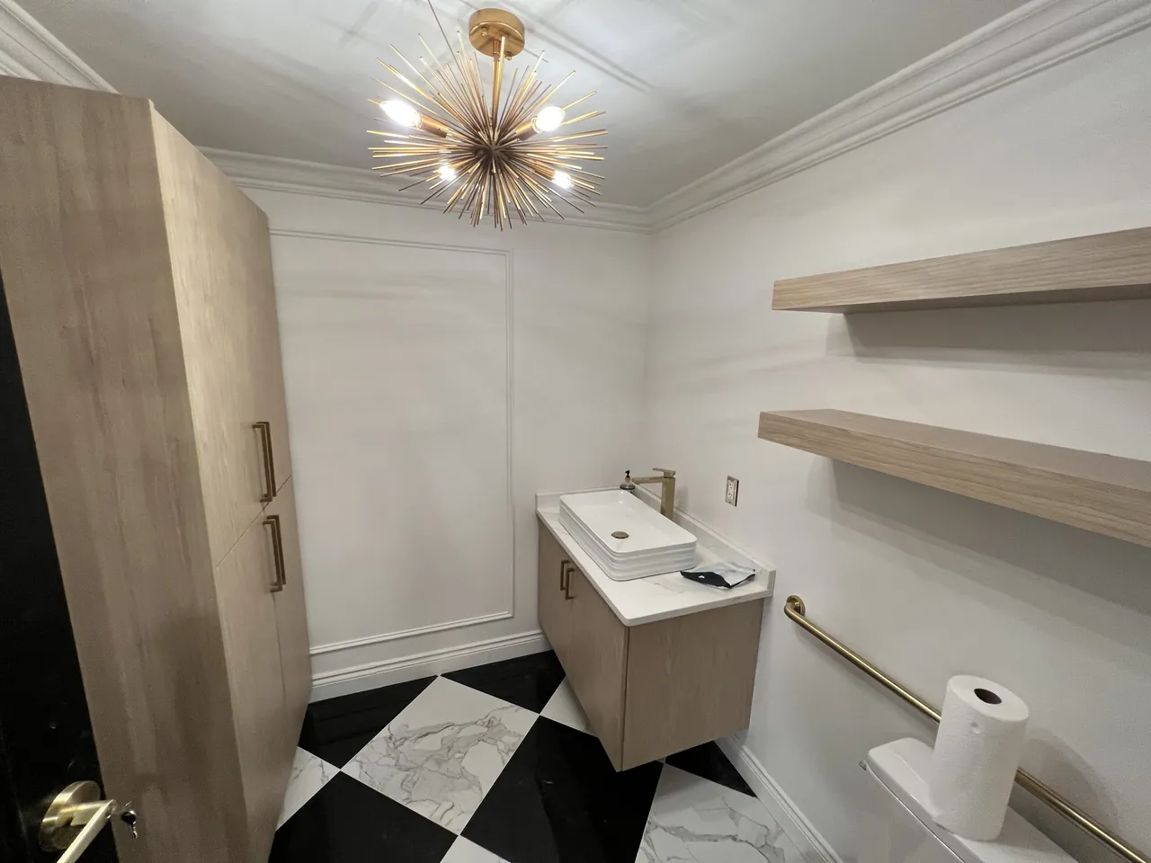 Restroom with a floating wood vanity, floating shelves and a tall cabinet by Mason Oak Carpentry in Detroit, MI