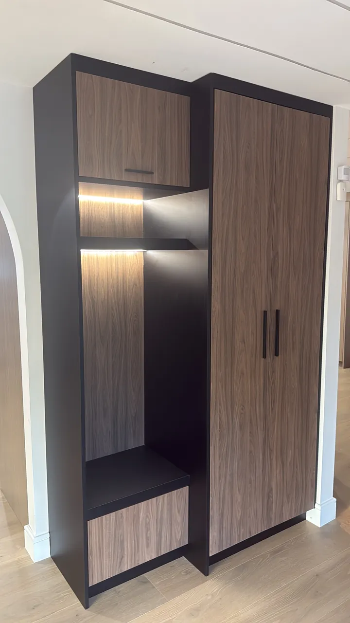 Mudroom locker with a lit bench nook and a walnut tall cabinet by Mason Oak Carpentry in Detroit, MI